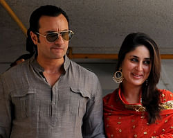 Newly-wedded Bollywood personalities Saif Ali Khan (L) and Kareena Kapoor arrive to pose for the media outside Khan's residence in Mumbai . AFP