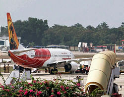 An Abu Dhabi-Kochi Air India flight parked at the airport in Thiruvananthapuram on Friday. High drama unfolded at the airport on Friday when the pilot of the plave pressed the hijack button in panic after passengers created a ruckus in the cockpit following diversion of the plane to Thiruvananthapuram. PTI