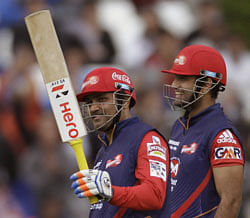 Delhi Daredevils Virender Sehwag, left, holds his bat up as he makes over fifty runs against Perth Scorchers during a Champions League Twenty20 game in Cape Town, South Africa, Sunday, Oct. 21, 2012.  AP