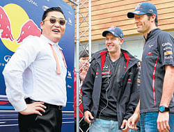 Korean sensation Psy with Red Bull drivers Sebastian Vettel (centre) and Mark Webber during the Korean Grand Prix last week. AFP