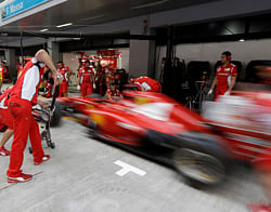 Ferrari mechanics practice their pit stops ahead of the Indian Formula One Grand Prix at the Buddh International Circuit in Noida, on the outskirts of New Delhi, India, Thursday, Oct. 25, 2012. (AP Photo