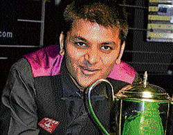 over the moon Rupesh Shah poses with the World point format billiards trophy on Saturday.