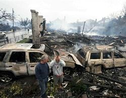 Residents look over the remains of burned homes in the Rockaways section of New York, October 30, 2012.  REUTERS