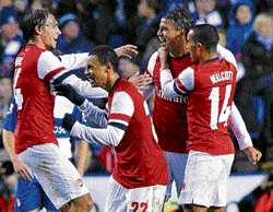 super strike: Arsenal's Marouane Chamakh (second from right) celebrates with team-mates after scoring their fifth goal during extra time of their English League Cup match against Reading on Tuesday. AFP