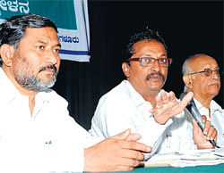 MAKING A POINT: Social activist T J Abraham speaks at Nice Road victimsmeeting in Bangalore on Wednesday. He is flanked by Dalit Sangarsha Samiti convener R Mohanraj and former MLC, A K Subbaiah.DH PHOTO