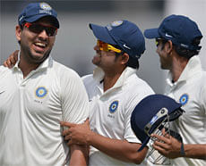 India 'A' cricketers Yuvraj Singh (L), Suresh Raina (C) and Manoj Tiwary share a a light moment as they walk back after the end of the England innings on the final day of a three day practice match between India 'A' and England at The Cricket Club of India (CCI) ground in Mumbai on November 1, 2012. The England cricket team, who are to play a four Test series against India from November 15, are playing three practice matches before the start of the test series. AFP PHOTO