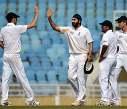 England bowler Monty Panesar (C) celebrates with team mates after taking the wicket of Mumbai 'A' batsman Nikhil Patil during the final day of a three day cricket practice match between Mumbai 'A' and England at The D.Y. Patil stadium in Navi Mumbai on November 5, 2012. AFP