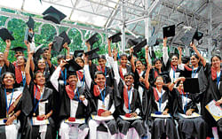Achievers: Students celebrate after receiving the gold medals during the sixth annual convocation of Tumkur University held at Raj Bhavan in Bangalore on Monday.  DH Photo
