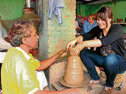 handy A German tourist tries her hand at pottery in Kumhaar Gaon.