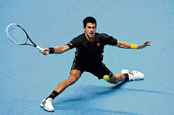 stretching out: Novak Djokovic returns during his victory over Jo-Wilfried Tsonga on Monday. AFP