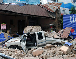 A car remains under the ruins of a collapsed house in San Marcos, 240 km of Guatemala City, on November 7, 2012. . AFP Photo