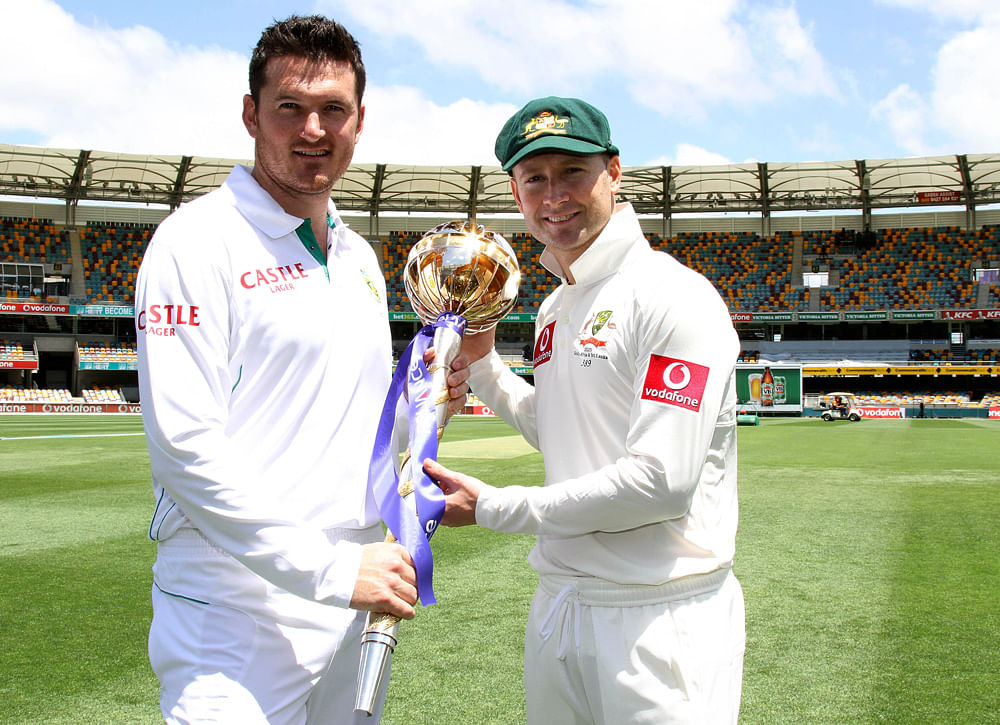 South African captain Graeme Smith, left, and Australian captain Michael Clarke pose for photographers with the trophy for their cricket test at the Gabba stadium in Brisbane, Australia, Thursday, Nov. 8, 2012. The first of three test matches between Australia and South Africa starts on Friday. (AP Photo