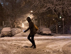 A woman walks in the snow during the nor'easter, also known as a northeaster storm, in Jersey City, New Jersey. A wintry storm dropped snow and rain on the U.S. Northeast, bringing dangerous winds and knocking out power in a region where hundreds of thousands were still in the dark after Superstorm Sandy. REUTERS