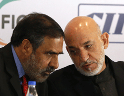 Afghanistan President Hamid Karzai (R) with Commerce  Minister Anand Sharma in Mumbai on Saturday. REUTERS