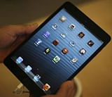 A man holds an iPad mini in Los Angeles, California, November 2, 2012.  Credit: Reuters