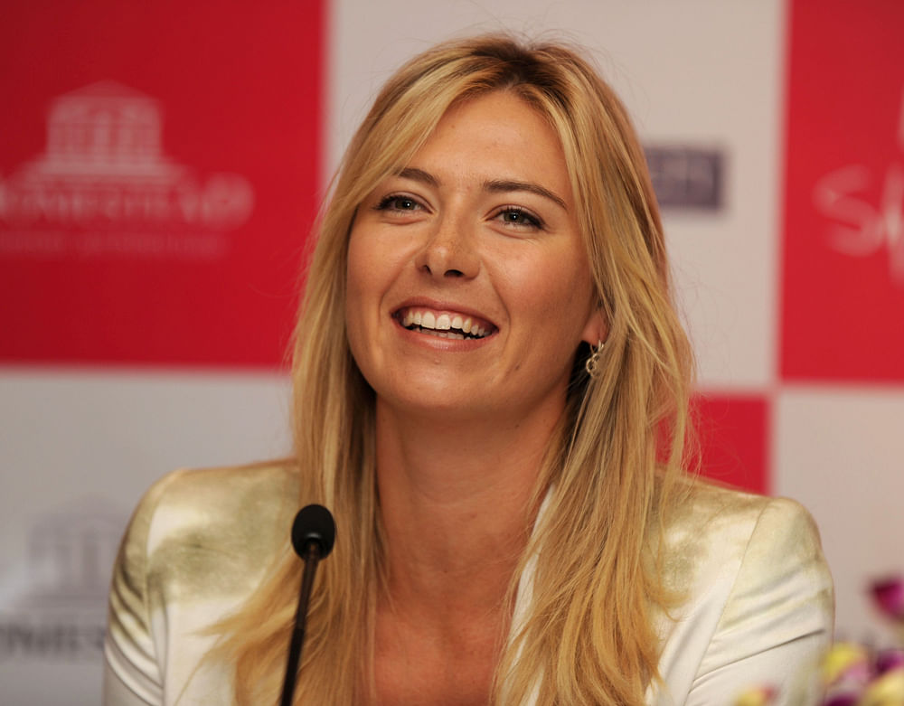 Russian professional tennis player Maria Sharapova smiles during a media function in New Delhi on November 11,2012. Sharapova came to Delhi as part of a promotional event. AFP PHOTO