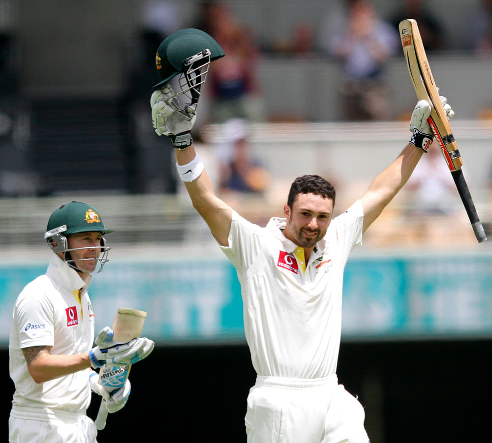 Australia's Ed Cowan (R) celebrates his century against South Africa as his teammate Michael Clarke looks on during the first cricket test match at the Gabba in Brisbane November 12, 2012. REUTERS