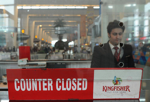 In this photograph taken on October 20, 2012, a customer service representative stands inside the closed window of a Kingfisher Airlines booking counter at the International airport in New Delhi. India's troubled Kingfisher Airlines, which has been grounded since October, posted a record second-quarter loss on November 8, 2012, as revenues crashed, intensifying concerns about the carrier's future. AFP