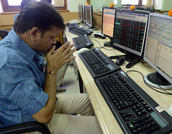 An Indian stock trader prays in front of his trading terminal before Muhurat Trading - a special trading session on the occasion of Diwali, the Festival of Lights - at a brokerage house in Mumbai on November 13, 2012. India's Sensex index slid 0.28 percent or 51.47 points at 18,618.87 points on November 13, its fourth straight day of declines, a day after industrial output shrank by a surprise 0.4 percent in September. Healthcare, real-estate and auto stocks fell in cautious trade, which marked token ceremonial trading during the Hindu festival of Diwali. AFP