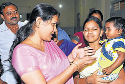 Energy Minister Shobha Karandlaje interacting with kids of Ramakrishna Sevashrama, in Puttur on Tuesday.