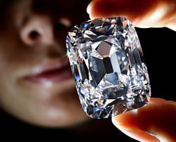 A model holds the 'Archduke Joseph' historial diamond during a Christie's auction preview in Geneva. Once part of the collection of the Archduke Joseph of Austria (1872-1962), the D color diamond, weighing 76,02 carats and mined at the legendary Indian Golkonda mine, is expected to reach between 15 million and 20 million US dollars at an auction on November 13 in Geneva. AFP PHOTO