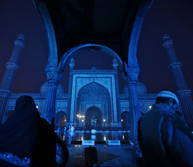 Muslims sit at New Delhi's Jama Masjid, illuminated with blue lights as a part of a diabetes awareness and prevention campaign on November 7. Reuters
