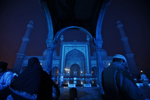 Muslims sit at the Jama Masjid (Grand Mosque), illuminated with blue lights as a part of a diabetes awareness and prevention campaign organized by pharmaceutical company Sanofi India, in the old quarters of Delhi November 7, 2012. Picture taken November 7, 2012. REUTERS