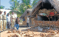 Police inspect the collapsed house at S Devaganahalli,  Shidlaghatta taluk, on Wednesday. dh photo