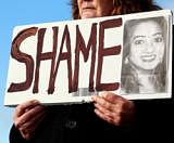 Mary Phelan holds a picture of Savita Halappanavar in protest outside University Hospital Galway in Galway, Ireland November 15, 2012. The Irish government on Thursday pledged to urgently clarify its vague abortion laws after an Indian woman died in an Irish hospital after being denied a termination, sparking an outcry from voters and criticism from the Indian government. Thousands held a candle-lit vigil outside parliament on Wednesday after the news broke of death of Savita Halappanavar, 31, from septicaemia days after miscarrying 17 weeks into her pregnancy and her husband said she had been denied an abortion. REUTERS