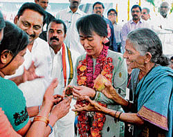 Token of affection: Myanmar's opposition leader Aung San Suu Kyi being presented with bangles by women during her visit to Papasanipalli village in Anantapur district in Andhra Pradesh on Saturday. Chief Minister Kiran Kumar Reddy is also seen. PTI