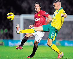 on the ball Manchester United's Rafael Da Silva (left) and Norwich City's Anthony Pilkington vie for possession during their match at Carrow Road on Saturday. AP