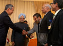 Prime Minister Manmohan Singh inter dues members of his delegation to his Singaporean counterpart, Lee Hsien Loong during a Bilateral Meeting in Phnom Penh, Cambodia on Sunday. PTI