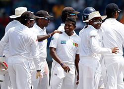 Sri Lanka's Rangana Herath (C) celebrates with teammates after taking the wicket of New Zealand's James Franklin during the third day of their first test cricket match in Galle November 19, 2012. REUTERS