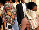 In this Monday, Nov.19, 2012 photo, face covered Shaheen Dhada, left, and Renu Srinivas, Indian women arrested for their Facebook posts, come out of a court in Mumbai, India, Tuesday, Nov. 20, 2012. As India's financial capital shut down for the weekend funeral of a powerful right-wing politician linked to waves of mob violence, Shaheen Dhada posted on Facebook that the closures in Mumbai were 'due to fear, not due to respect.' Renu Srinivas, a friend of hers hit the 'like' button. For that, both women were arrested. Analysts and the media are slamming the Maharashtra state government for what they said was a flagrant misuse of the law and an attempt to curb freedom of expression. (AP