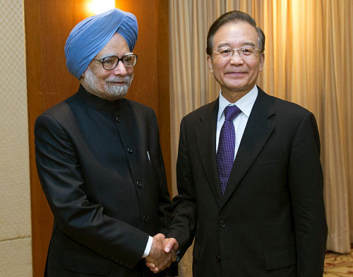 In this photo released by China's Xinhua News Agency, Indian Prime Minister Manmohan Singh, left, and Chinese Premier Wen Jiabao pose for photographers during their meeting held on the sidelines of Southeast Asia Summit in Phnom Penh, Cambodia, Monday, Nov. 19, 2012. AP