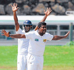 WRECKER-IN-CHIEF Sri Lankas Rangana Herath (right) successfully appeals for a leg before verdict against New Zeal-ands Ross Taylor in the first Test in&#8200;Galle on Monday. AFP