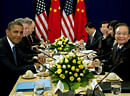 U.S. President Barack Obama, left, winks as media leaves the room during a meeting with Chinese Premier Wen Jiabao, right, during the East Asia Summit at the Peace Palace in Phnom Penh, Cambodia, Tuesday, Nov. 20, 2012. AP
