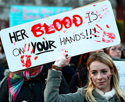 A woman holds a poster during a vigil in Dublin  in memory of Savita Halappanavar and in support of changes to abortion law. A wave of protests have taken place across Ireland in recent days in response to the death of 31-year old Halappanavar who died of septicaemia following a miscarriage 17 weeks into her pregnancy. REUTERS