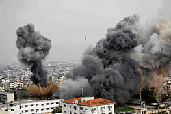Pounded: Smoke billows from the site of an airstrike in Gaza City on  Wednesday after Israeli aircraft pounded the Gaza with at least 30 strikes overnight, hitting government ministries, smuggling tunnels, a banker's empty villa and a Hamas-linked media office. AP
