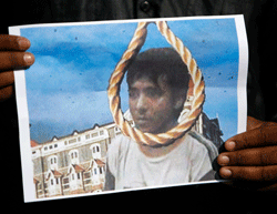 A man holds a picture of Mohammad Ajmal Kasab with a noose, as he celebrates Kasab's execution, in the western Indian city of Ahmedabad November 21, 2012. India executed Kasab, the lone survivor of a militant squad that killed 166 people in a rampage through the financial capital Mumbai in 2008, hanging him on Wednesday just days before the fourth anniversary of the attack. REUTERS