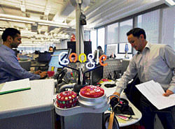 Time to pay up: A neon Google logo is seen as employees work at the new Google office in Toronto. REUTERS