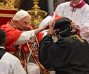 India's Baselios Cleemis Thottunkal receives his hat as Pope Benedict XVI (L) appoints him as a cardinal during a ceremony on November 24, 2012 at St Peter's basilica at the Vatican. Six non-European prelates are set to join the Catholic Church's College of Cardinals, a move welcomed by critics concerned that the body which will elect the future pope is too Eurocentric. AFP PHOTO / VINCENZO PINTO