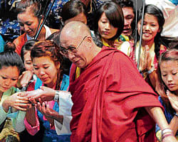 spreading peace: Tibetan spiritual leader the Dalai Lama interacts with students at a college in Bangalore on Monday. dh photo/kishore kumar bolar