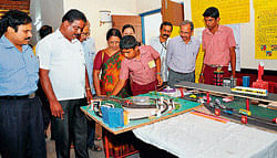 Confluence of ideas: Participants show their model on the theme Transport and                           Communication to ZP Vice President Rithesh Shetty (second from left) and CEO Dr Vijaya Prakash (extreme left) during the District-level Science models exhibition at Pilikula on Wednesday. (Right) Thejashree and Vaishnavi of Canara Girls High School with their model which explains the chain reaction in a Nuclear Power plant. DH Photos
