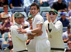 Australia's Ricky Ponting (L) and Mike Hussey (R) congratulate team mate Mitchell Starc (C) for bowling out South Africa's Alviro Petersen during the first day's play of the third cricket test match, at the WACA in Perth November 30, 2012. REUTERS/Stringer