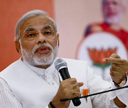 Gujarat Chief Minister Narendra Modi interacts with the media after the release of BJP's manifesto ahead of Assembly elections, at a press conference in Ahmedabad on Monday. PTI