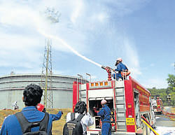 we are ready: Firemen in action during the mock drill organised at MRPL on Tuesday.