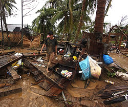 Residents walk amongst their destroyed houses after Typhoon Bopha hit Compostela town, Compostela Valley province, in southern island of Mindanao on December 4, 2012. Typhoon Bopha killed 43 people in one hard-hit Philippine town December 4, local television station ABS-CBN reported from the scene. AFP PHOTO