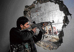 loss of control: A Free Syrian Army fighter aims his weapon during clashes with government forces in Aleppo, Syria. AP