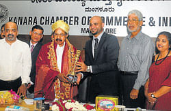 Kanara Chamber of Commerce and Industry President Mohammed Ameen felicitates Union Minister of Petroleum and Natural Gas M Veerappa Moily in Mangalore on Friday. dh photo